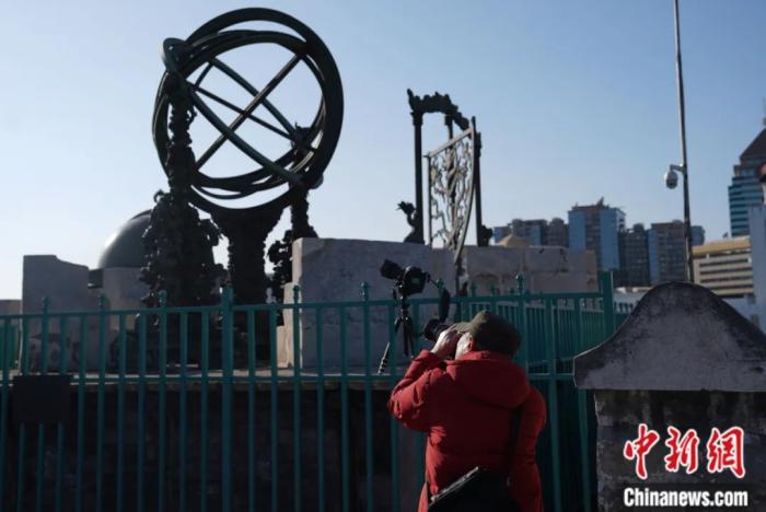 Astronomers photograph a partial solar eclipse at the Beijing Ancient Observatory. Photo by Sudan